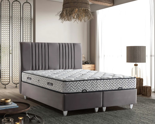 Harmaa tekstiilivuode modernilla patjalla