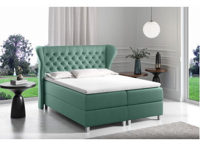 Bett Chesterfield -jousityynyvuodesohva king size -sänky sekä hotellimakuuhuone uutena.
