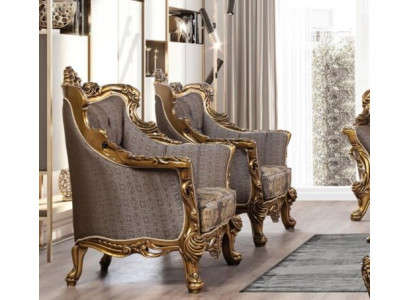 Ylellinen klassinen nojatuoli tummanharmaalla kullatulla barokkikuvioinnilla Chesterfield-tyylistä.